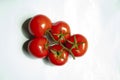 Red tomatoes bunch on light background.Fresh picked vegetables