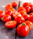 Red tomatoes cherry on dark wooden board, closeup Royalty Free Stock Photo