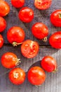 Red tomatoes cherry on dark wooden board,top view Royalty Free Stock Photo