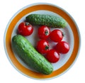 Red tomatoes and cucumbers on a plate on a white background