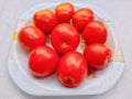 Red tomatoes fruit tomato vegetable tomat timatar pomidor tomate in a plate closeup view image photo Royalty Free Stock Photo