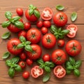 Red tomatoes and green basil leaves are arranged on a wooden surface Royalty Free Stock Photo