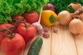 Red tomatoes, onions and garlic, peppers and cucumbers on a table Royalty Free Stock Photo