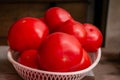 Red tomatoes in a plastic basket. Sale of tomatoes at the farmers\' market. Red ripe tomatoes Royalty Free Stock Photo