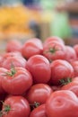 Red tomatoes in a supermarket. raw tomatoes on market. Fresh red tomatoes in supermarket. Vertical photo