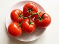 Red tomatoes on white plate Royalty Free Stock Photo