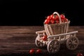 Red tomatoes in wicker basket on wooden table Royalty Free Stock Photo