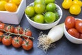 Red tomatoes, yellows, greens and chives