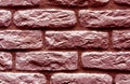 Red toned brick wall surface.