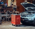 Red tool box in a garage. Royalty Free Stock Photo