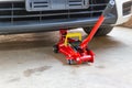 Red tool jack lift car for repair check Royalty Free Stock Photo