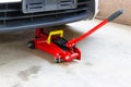 Red tool jack lift car for repair check Maintenance Royalty Free Stock Photo