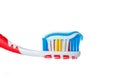 Red toothbrush with blue two color toothpaste on light surface Royalty Free Stock Photo