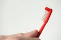 Red toothbrush in hand Royalty Free Stock Photo