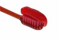 Red toothbrush with red toothpaste isolate on a white background close-up. Royalty Free Stock Photo