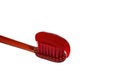 Red toothbrush with red toothpaste isolate on a white background close-up. Royalty Free Stock Photo