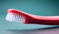 A red toothbrush with white bristles