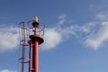 Red top navigation light tower over a blue sky with clouds. Royalty Free Stock Photo