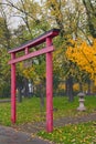 Red Torii Gate in Japanese garden in Kyiv. Text on sign: Kyoto park. Scenic rainy morning landscape Royalty Free Stock Photo