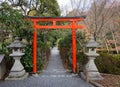 A red torii with stone lanterns at garden