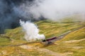 The red tourist vintage steam train ascending to the Brienzer Rothorn