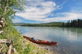 Red towed and abandoned canoe on Yukon River