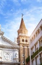 Red tower and a cathedral on the narrow street. Venice, Italy Royalty Free Stock Photo