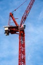 Red Tower Cranes Against A Blue Sky With No People