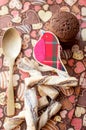 Red toy bird and cookies on dark napkin with image of hearts