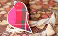 Red toy bird and cookies on dark napkin with image of hearts Royalty Free Stock Photo