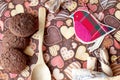 Red toy bird and cookies on dark napkin with image of hearts