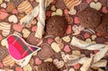 Red toy bird and cookies on dark napkin with image of hearts