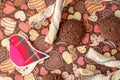Red toy bird and cookies on dark napkin with image of hearts Royalty Free Stock Photo