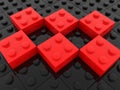 Red toy bricks on black toy bricks close-up