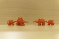Red toy camels standing in two rows against each other. Abstract divorce or stepfamily concept.