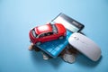 Red toy car, calculator and coins on the blue background Royalty Free Stock Photo