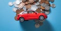 Red toy car and coins on the blue background Royalty Free Stock Photo