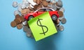 Red toy car and coins on the blue background Royalty Free Stock Photo