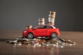 Red toy car and coins on the desk Royalty Free Stock Photo