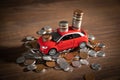Red toy car and coins on the desk Royalty Free Stock Photo