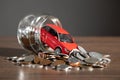 Red toy car and coins on the desk Royalty Free Stock Photo