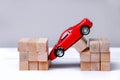 Red toy car falls into the abyss. Royalty Free Stock Photo