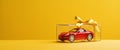 A Red Toy Car In A Gift Box With A Yellow Bow Royalty Free Stock Photo