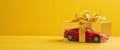 A Red Toy Car In A Gift Box With A Yellow Bow Royalty Free Stock Photo