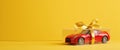 A Red Toy Car In A Gift Box With A Yellow Bow Royalty Free Stock Photo