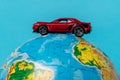 Red toy car on a globe. Travel, tourism concept Royalty Free Stock Photo