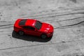 Red toy car on grey wooden background with space for lettering or design. Close up Royalty Free Stock Photo