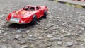 Red toy car on ground