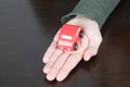 Red toy car over palm of man hand Royalty Free Stock Photo