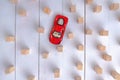 Red toy car overcomes all obstacles and barriers reaching the goal. Royalty Free Stock Photo
